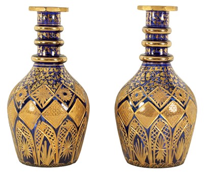Lot 9 - A LARGE PAIR OF 19TH CENTURY BOHEMIAN CUT GILT AND BRISTOL BLUE SERVING BOTTLES
