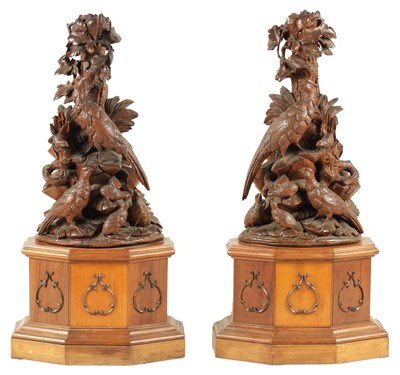 Lot 585 - A LARGE PAIR OF LATE 19TH CENTURY CARVED BLACK FOREST CANDLE STANDS