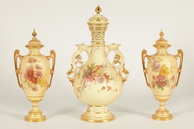 Lot 52 - AN ORNATE ROYAL WORCESTER GILT AND IVORY GROUND SCROLLED TWO-HANDLED CABINET VASE AND COVER