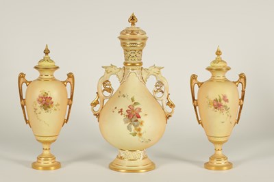 Lot 52 - AN ORNATE ROYAL WORCESTER GILT AND IVORY GROUND SCROLLED TWO-HANDLED CABINET VASE AND COVER