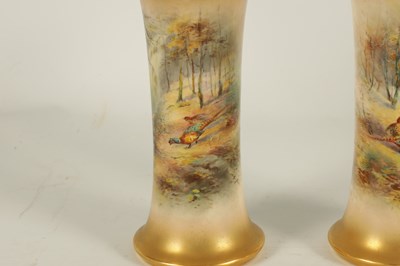 Lot 40 - JAMES STINTON. A PAIR OF ROYAL WORCESTER GILT EDGED FLARED CYLINDRICAL CABINET VASES