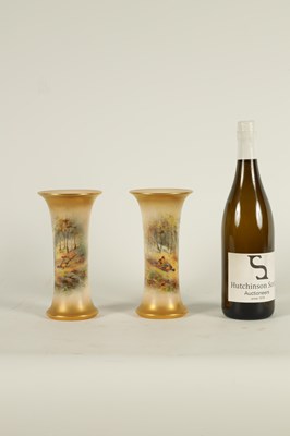 Lot 40 - JAMES STINTON. A PAIR OF ROYAL WORCESTER GILT EDGED FLARED CYLINDRICAL CABINET VASES