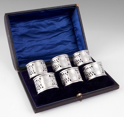 Lot 242 - A SET OF SIX EDWARDIAN SILVER NAPKIN RINGS...