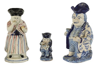 Lot 37 - THREE 18TH CENTURY BLUE AND WHITE DELFTWARE TOBY JUGS