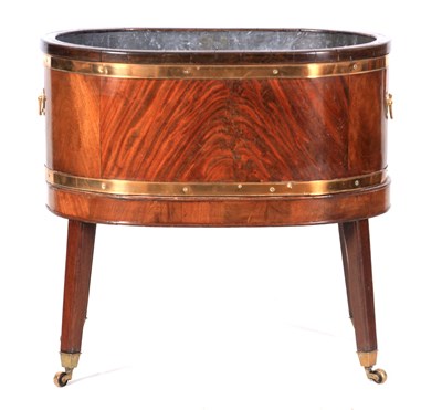 Lot 1067 - A GEORGE III FLAME MAHOGANY BRASS BOUND WINE COOLER OF OVAL FORM