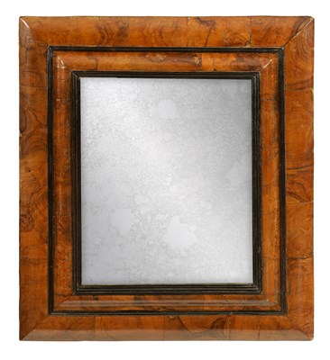 Lot 734 - A WILLIAM AND MARY FIGURED WALNUT AND EBONISED CUSHION FRAMED HANGING MIRROR