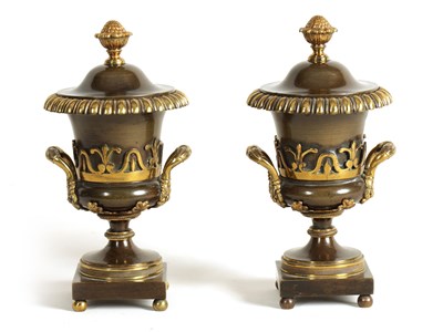 Lot 543 - A PAIR OF REGENCY BRONZE AND GILT BRONZE URN SHAPED CASSOLETES/CANDLESTICKS