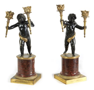 Lot 565 - A PAIR OF EARLY 19TH CENTURY FRENCH GILT BRONZE AND ROUGE MARBLE TWO BRANCH STANDING CHERUB CANDELABRA