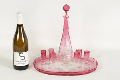 Lot 31 - AN ART NOUVEAU RUBY AND CLEAR GLASS MOSER DECANTER, TRAY AND SIX GLASSES