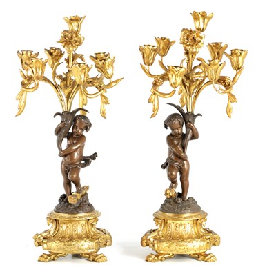 Lot 940 - A PAIR OF 19TH CENTURY BRONZE AND ORMOLU SEVEN BRANCH CANDELABRA