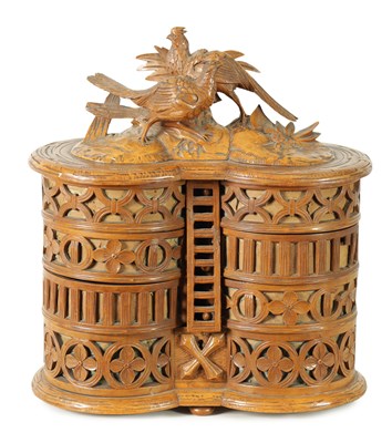 Lot 755 - A LATE 19TH CENTURY BLACK FOREST CARVED LINDEN WOOD SEWING BOX