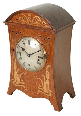 Lot 745 - A GERMAN ART NOUVEAU OAK CASED INLAID QUARTER CHIMING BRACKET CLOCK