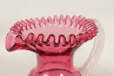 Lot 4 - A GRADUATED PAIR OF 19TH CENTURY STYLE OVERSIZED CRANBERRY GLASS JUGS