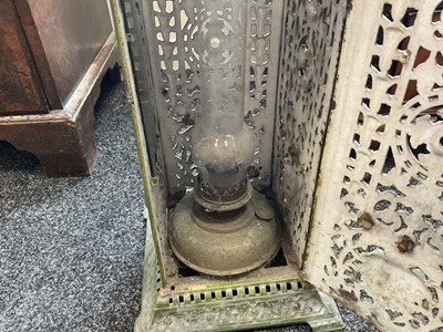 Lot 601 - A 19TH CENTURY CAST IRON OIL BURNER/HEATER