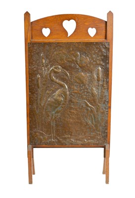 Lot 920 - AN ARTS AND CRAFTS PRESSED BRASS AND OAK FIRE SCREEN