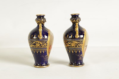 Lot 107 - A PAIR OF LATE 19TH CENTURY VIENNA STYLE GILT AND ROYAL BLUE GROUND TWO-HANDLED CABINET VASES