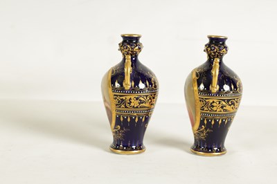 Lot 107 - A PAIR OF LATE 19TH CENTURY VIENNA STYLE GILT AND ROYAL BLUE GROUND TWO-HANDLED CABINET VASES