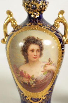 Lot 107 - A PAIR OF LATE 19TH CENTURY VIENNA STYLE GILT AND ROYAL BLUE GROUND TWO-HANDLED CABINET VASES