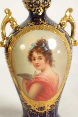 Lot 107 - A PAIR OF LATE 19TH CENTURY VIENNA STYLE GILT AND ROYAL BLUE GROUND TWO-HANDLED CABINET VASES