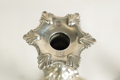 Lot 247 - A FINE SET OF FOUR GEORGE III LARGE CAST SILVER TABLE CANDLE STICKS IN THE ROCOCO MANNER
