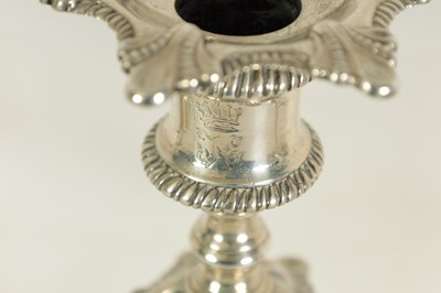 Lot 247 - A FINE SET OF FOUR GEORGE III LARGE CAST SILVER TABLE CANDLE STICKS IN THE ROCOCO MANNER