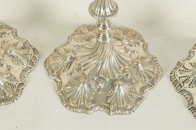 Lot 247 - A FINE SET OF FOUR GEORGE III LARGE CAST SILVER TABLE CANDLE STICKS IN THE ROCOCO MANNER