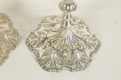 Lot 247 - A FINE SET OF FOUR GEORGE III LARGE CAST SILVER TABLE CANDLE STICKS IN THE ROCOCO MANNER