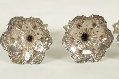 Lot 247 - A FINE SET OF FOUR GEORGE III LARGE CAST SILVER TABLE CANDLE STICKS IN THE ROCOCO MANNER
