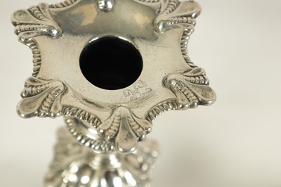 Lot 247 - A FINE SET OF FOUR GEORGE III LARGE CAST SILVER TABLE CANDLE STICKS IN THE ROCOCO MANNER
