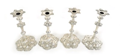 Lot 247 - A FINE SET OF FOUR GEORGE III LARGE CAST SILVER TABLE CANDLE STICKS IN THE ROCOCO MANNER