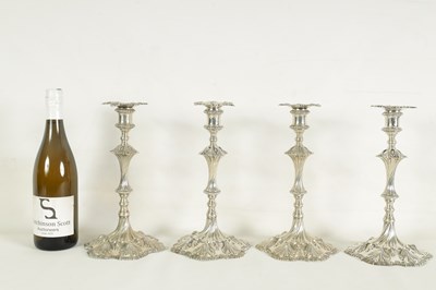 Lot 247 - A FINE SET OF FOUR GEORGE III LARGE CAST SILVER TABLE CANDLE STICKS IN THE ROCOCO MANNER