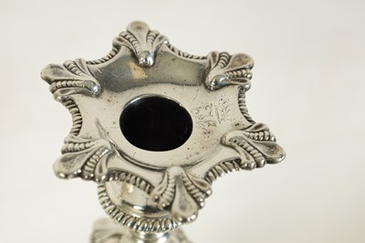 Lot 247 - A FINE SET OF FOUR GEORGE III LARGE CAST SILVER TABLE CANDLE STICKS IN THE ROCOCO MANNER