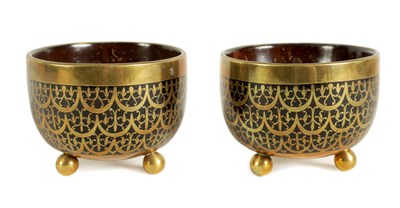 Lot 589 - A PAIR OF BRASS INLAID COCONUT SHELL BOWLS
