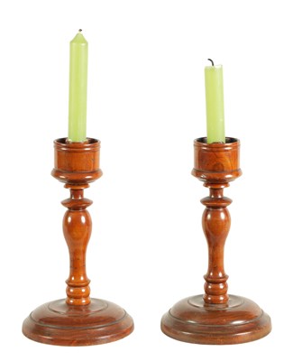 Lot 922 - A PAIR OF 19TH CENTURY TURNED WALNUT CANDLESTICKS