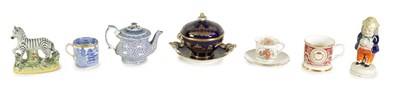Lot 77 - AN EARLY 19TH CENTURY STAFFORDSHIRE MODEL OF A ZEBRA, A STAFFORDSHIRE FIGURAL PEPPERETTE, A BLUE AND WHITE CUP, A TEAPOT WITH AN ORIENTAL LID, A ROYAL BLUE AND GILT PLATED BOWL ON STAND
