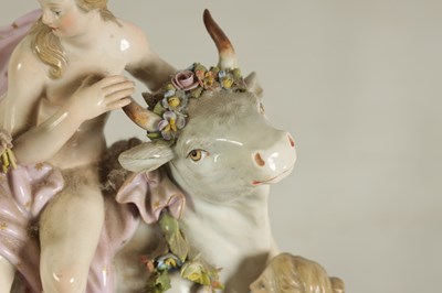 Lot 80 - A 19TH CENTURY MEISSEN FIGURE GROUP OF A BULL WITH A SEATED LADY RIDER AND A FLOWER SELLER