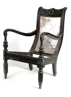 Lot 135 - AN EARLY 19TH CENTURY SRI LANKAN/CEYLONESE SOLID EBONY BERGERE ARMCHAIR