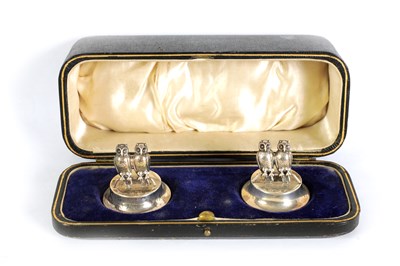 Lot 473 - A CASED PAIR OF EDWARDIAN SILVER OWL MENU HOLDERS