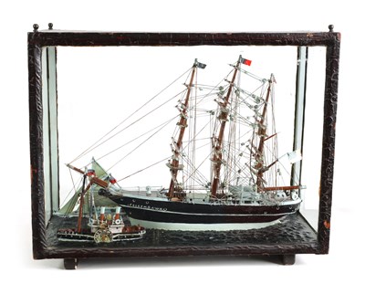 Lot 800 - A 19TH CENTURY MODEL OF A TRIPLE MASTED SHIP BEING TUGGED IN BY A STEAMBOAT