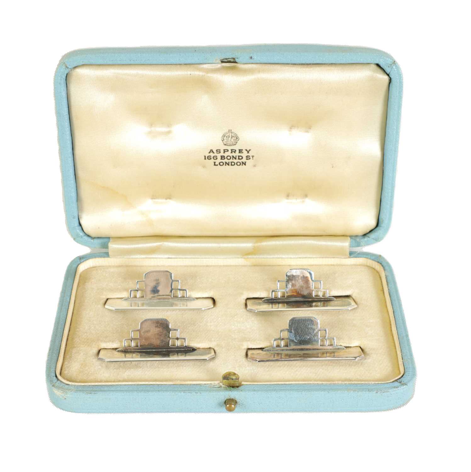 Lot 402 - A CASED SET OF FOUR ASPREY ART DECO SILVER MENU HOLDERS