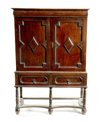 Lot 954 - AN EARLY 18TH CENTURY OAK GEOMETRIC MOULDED CABINET ON STAND