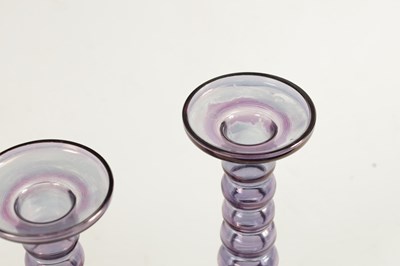 Lot 8 - A PAIR OF EARLY 20TH CENTURY IRIDESCENT AUBERGINE GLASS CANDLESTICKS