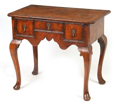 Lot 1421 - A GEORGE I FIGURED WALNUT AND HERRING-BANDED LOWBOY