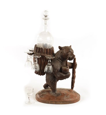 Lot 1118 - A LATE 19TH CENTURY SWISS CARVED BLACK FOREST BEAR DECANTER STAND
