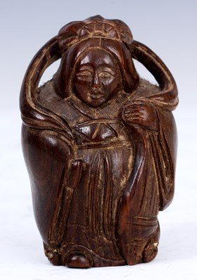 Lot 103 - A JAPANESE HARWOOD NETSUKE of a woman in...