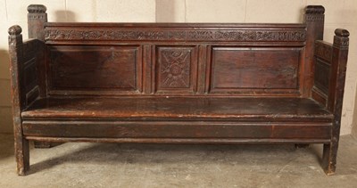 Lot 987 - A 17TH CENTURY CARVED WALNUT SPANISH SETTLE