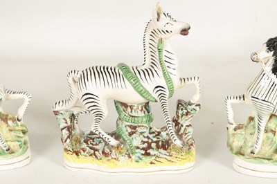 Lot 74 - A PAIR OF 19TH CENTURY STAFFORDSHIRE ZEBRAS AND A SIMILAR LARGER EXAMPLE