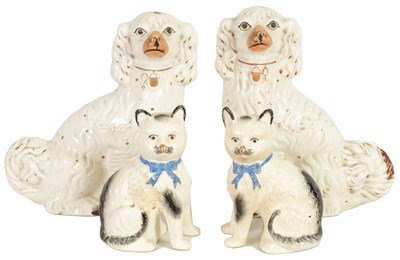 Lot 45 - A LARGE PAIR OF VICTORIAN SEATED STAFFORDSHIRE DOGS together with A PAIR OF SEATED MODELS OF CATS