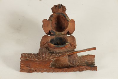 Lot 871 - A 19TH CENTURY BLACK FOREST CARVED LINDENWOOD INKWELL FORMED AS DOG RESTING ON A LOG
