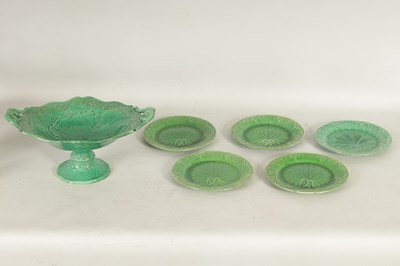 Lot 75 - FIVE 19TH CENTURY WEDGWOOD GREEN LEAF MOULDED PLATES, A SIMALR LARGE TWO HANDLED FOOTED TAZZA, A ST CLEMENT FRANCE PARROT JUG AND A POTTERY BAMBI FIGURE